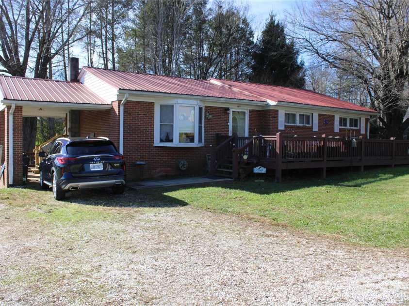 386 Morris Road, Brevard, NC 28712.  MLS# CAR4202834, YatesRealty ID 985. Front of House With Carport