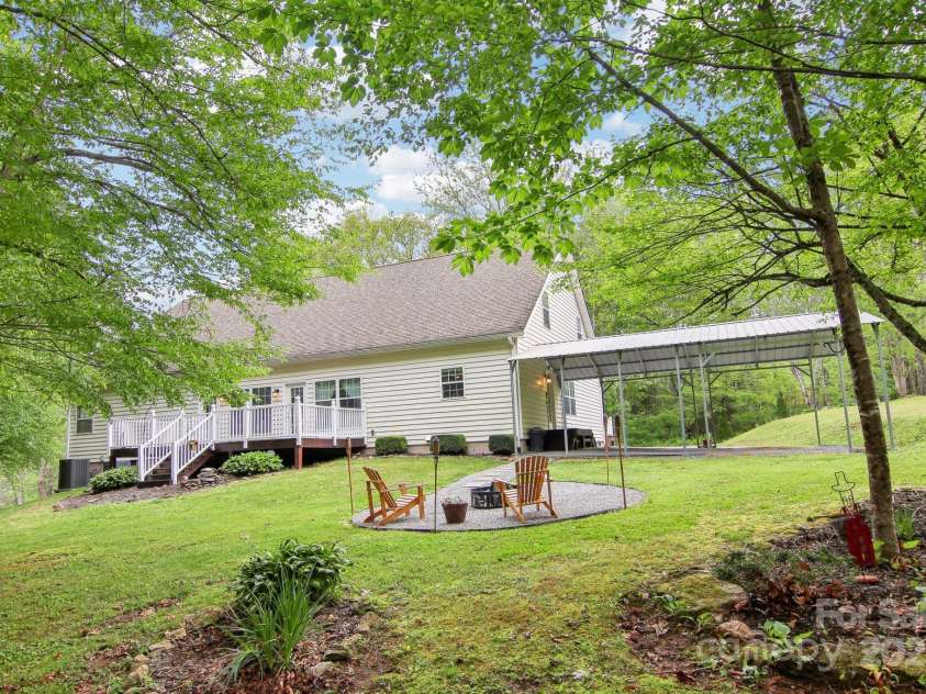 165 Sequoyah Drive, Waynesville, NC 28785.  MLS# CAR4249875, YatesRealty ID 9884. Enjoy tranquility with a creek and a newly installed firepit area—perfect for entertaining