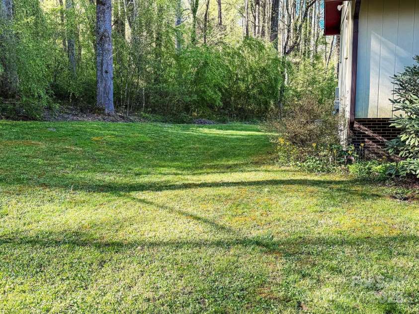 25 Pisgah Shadows Way, Hendersonville, NC 28739.  MLS# CAR4206550, YatesRealty ID 9897. Side yard
