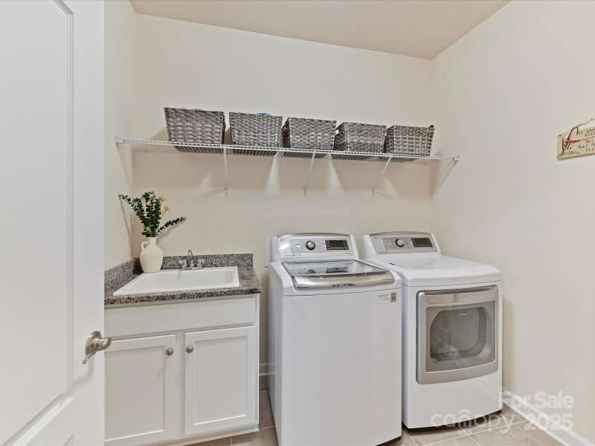 4989 Samoa Ridge Drive, Lancaster, SC 29720.  MLS# CAR4243510, YatesRealty ID 9898. Spacious Laundry Room with Utility Sink enhanced with Granite and Tiled Flooring