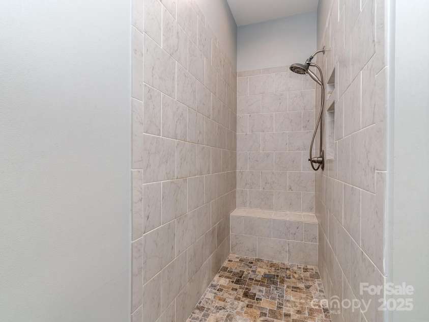 1141 Hollyheath Lane, Charlotte, NC 28209.  MLS# CAR4234094, YatesRealty ID 9923. Large walk-in shower in primary bath in addtion to a tub