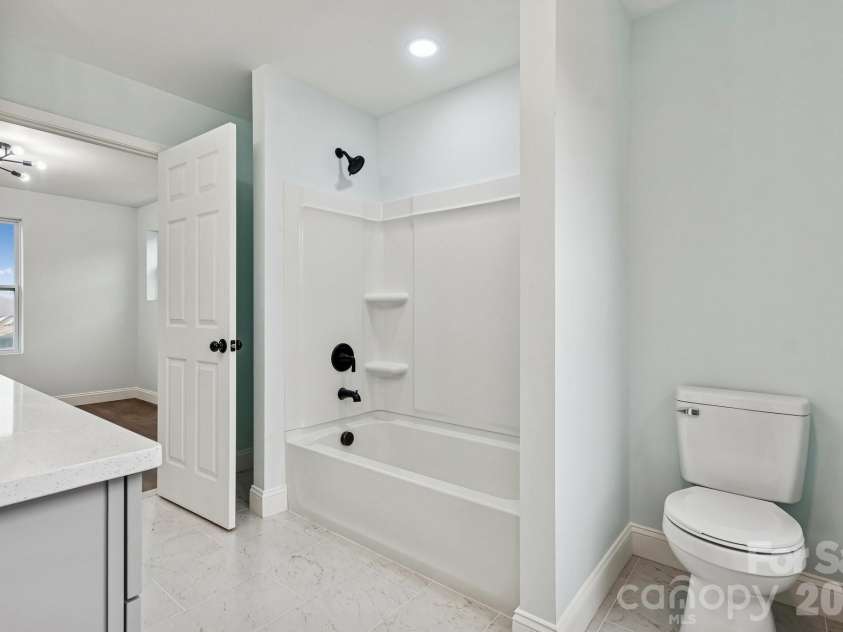 114 Strawberry Court, Lincolnton, NC 28092.  MLS# CAR4352512, YatesRealty ID 9926. Gorgeous Jack and Jill Bathroom with quartz counter top, tile flooring, elegant lighting, framed mirror and large windows for natural lighting