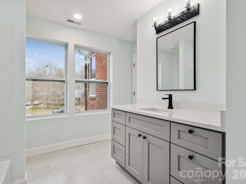 114 Strawberry Court, Lincolnton, NC 28092.  MLS# CAR4352512, YatesRealty ID 9926. Gorgeous Jack and Jill Bathroom with quartz counter top, tile flooring, elegant lighting, framed mirror and large windows for natural lighting