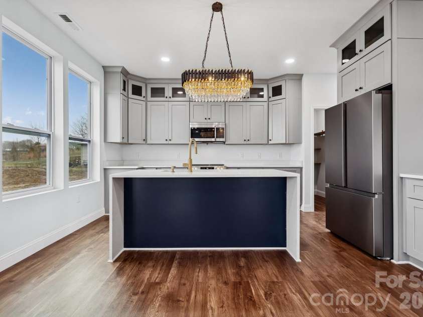 114 Strawberry Court, Lincolnton, NC 28092.  MLS# CAR4352512, YatesRealty ID 9926. Gorgeous kitchen area provides all of the stainless appliances needed for everyday cooking, large counter spacing, stacked cabinetry, elegant lighting and a waterfall quartz counter top island