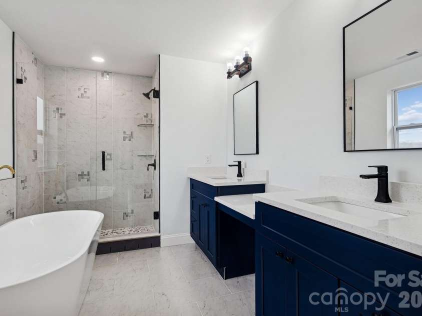 114 Strawberry Court, Lincolnton, NC 28092.  MLS# CAR4352512, YatesRealty ID 9926. Primary bedroom bathroom suite with his and hers sinks, makeup bar, soaking tub and tile walk-in shower