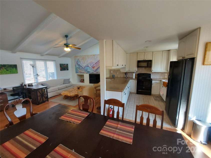 8015 Sullivan Drive, Charlotte, NC 28215.  MLS# CAR4223466, YatesRealty ID 9926. Prepare a meal in the galley kitchen with window looking outside over the sink. Enjoy the breakfast bar adjoining the vaulted living space!