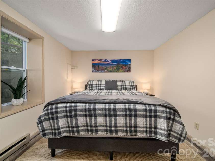37 Cherokee Trail, Fletcher, NC 28732.  MLS# CAR4357676, YatesRealty ID 9928. Basement bedroom 2 with king bed