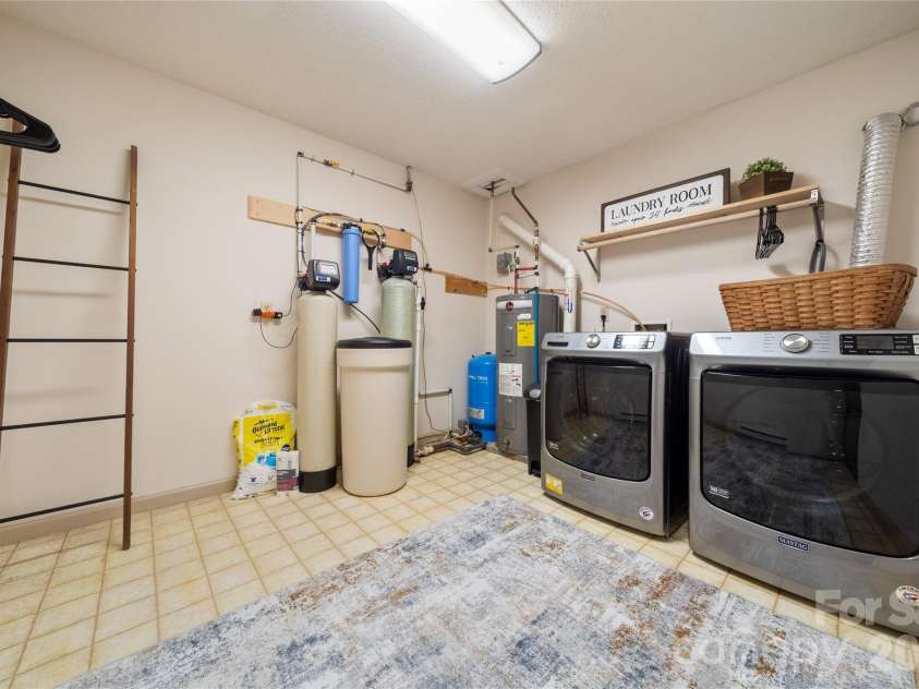 37 Cherokee Trail, Fletcher, NC 28732.  MLS# CAR4357676, YatesRealty ID 9928. Basemtn laundry and utiltiy with well equipment
