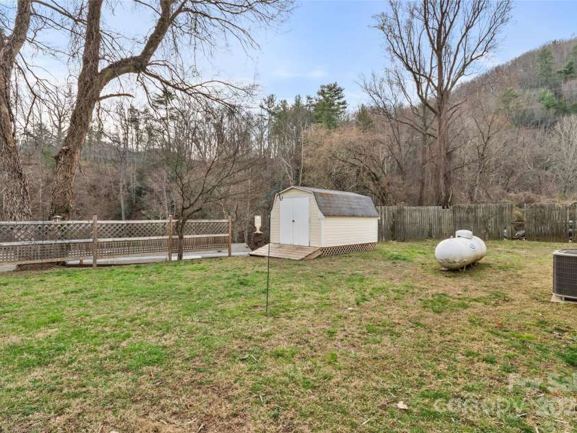 491 Lance Avenue, Hot Springs, NC 28743.  MLS# CAR4235506, YatesRealty ID 9947. Level, partially fenced backyard with storage shed