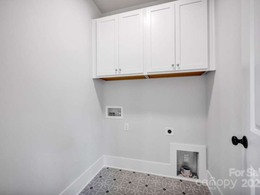 613 Hops Alley, Fort Mill, SC 29715.  MLS# CAR4193923, YatesRealty ID 9963. Laundry Room with Cabinets for Storage