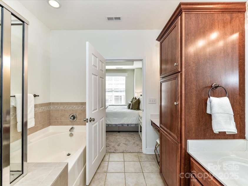 8925 Rosalyn Glen Road, Cornelius, NC 28031.  MLS# CAR4282773, YatesRealty ID 9965. Primary Bath with make up niche, garden tub, tiled shower, plenty of cabinet space for linens & tile floors!