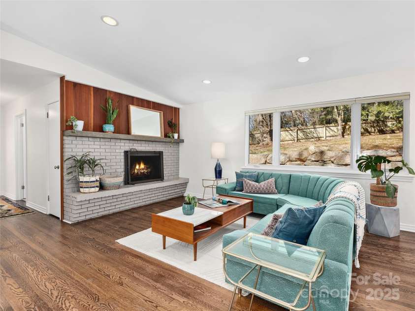 10 Woodcrest Road, Asheville, NC 28804.  MLS# CAR4221990, YatesRealty ID 9967. Wood-burning Fireplace with Mid Century Brick Hearth and Mahogany Wood Paneling