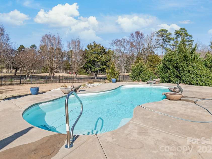 10615 Persimmon Creek Drive, Mint Hill, NC 28227.  MLS# CAR4232856, YatesRealty ID 9969. Stunning Saltwater Pool with Water Features