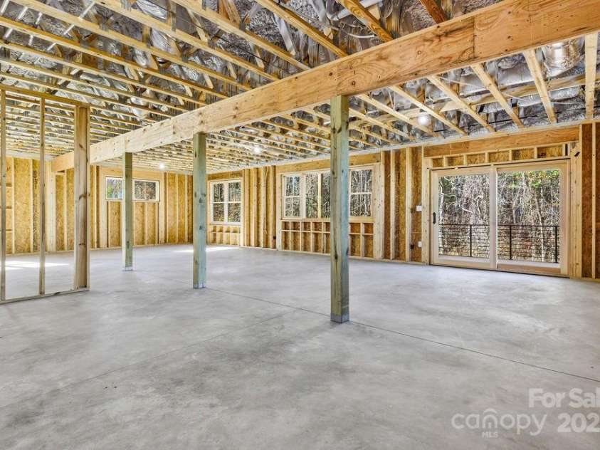202 Westridge Farm Road, Asheville, NC 28804.  MLS# CAR4312762, YatesRealty ID 997. Approx 1,600SF unfinished basement with high ceilings and exterior access—ready for future expansion