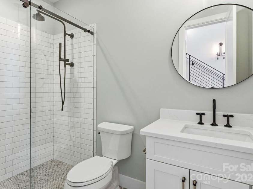 202 Westridge Farm Road, Asheville, NC 28804.  MLS# CAR4312762, YatesRealty ID 997. Beautifully appointed guest bath on main with modern finishes