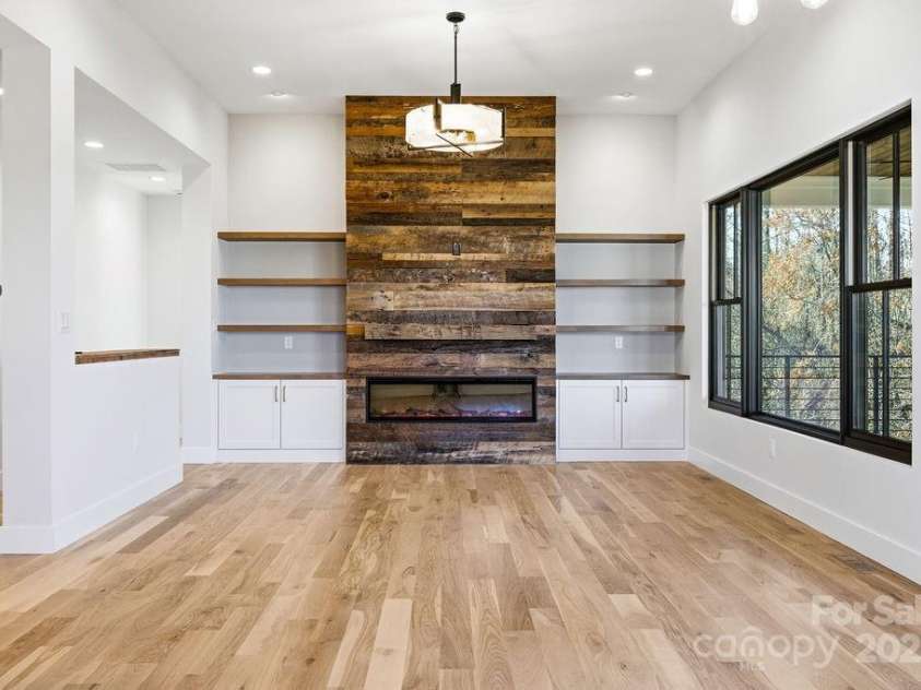 202 Westridge Farm Road, Asheville, NC 28804.  MLS# CAR4312762, YatesRealty ID 997. Dramatic floor-to-ceiling fireplace with custom built-ins