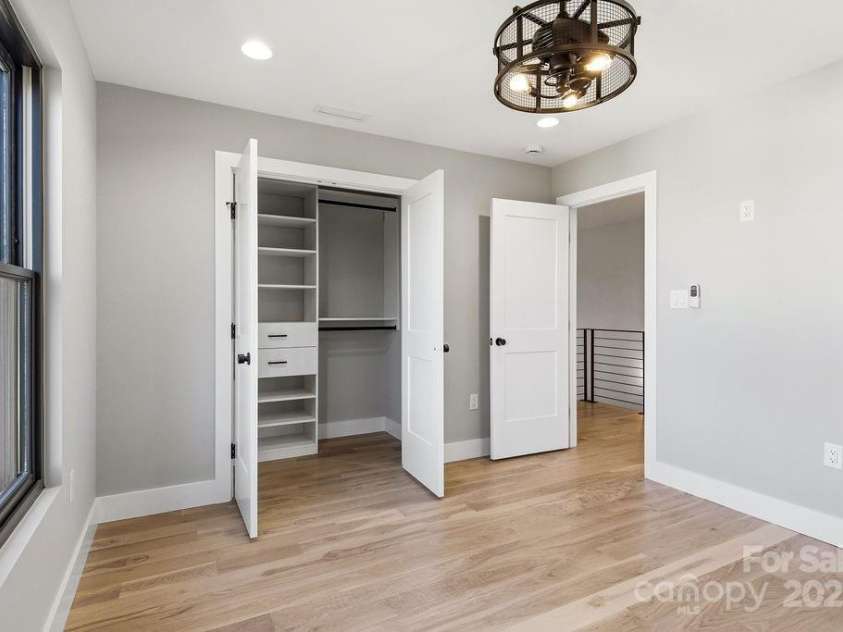 202 Westridge Farm Road, Asheville, NC 28804.  MLS# CAR4312762, YatesRealty ID 997. Sunny secondary bedroom with generous closet space and serene views