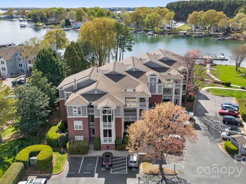 7844 Village Harbor Drive, Cornelius, NC 28031.  MLS# CAR4240892, YatesRealty ID 9972. Stunning bird’s-eye view captures the sunlit buildings and shimmering lake beyond!